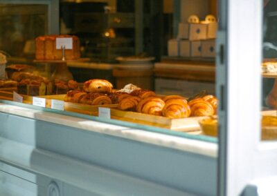 Tempting bakery assortment featuring croissants and sweets in a cozy indoor setting.