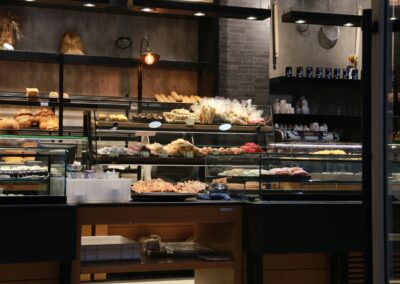 Inviting bakery interior showcasing a variety of fresh breads and pastries on display in a warm setting.